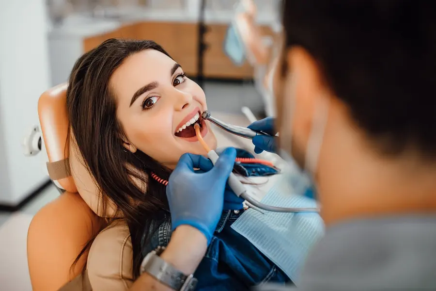 Patient smiling in the dental chair during a cleaning